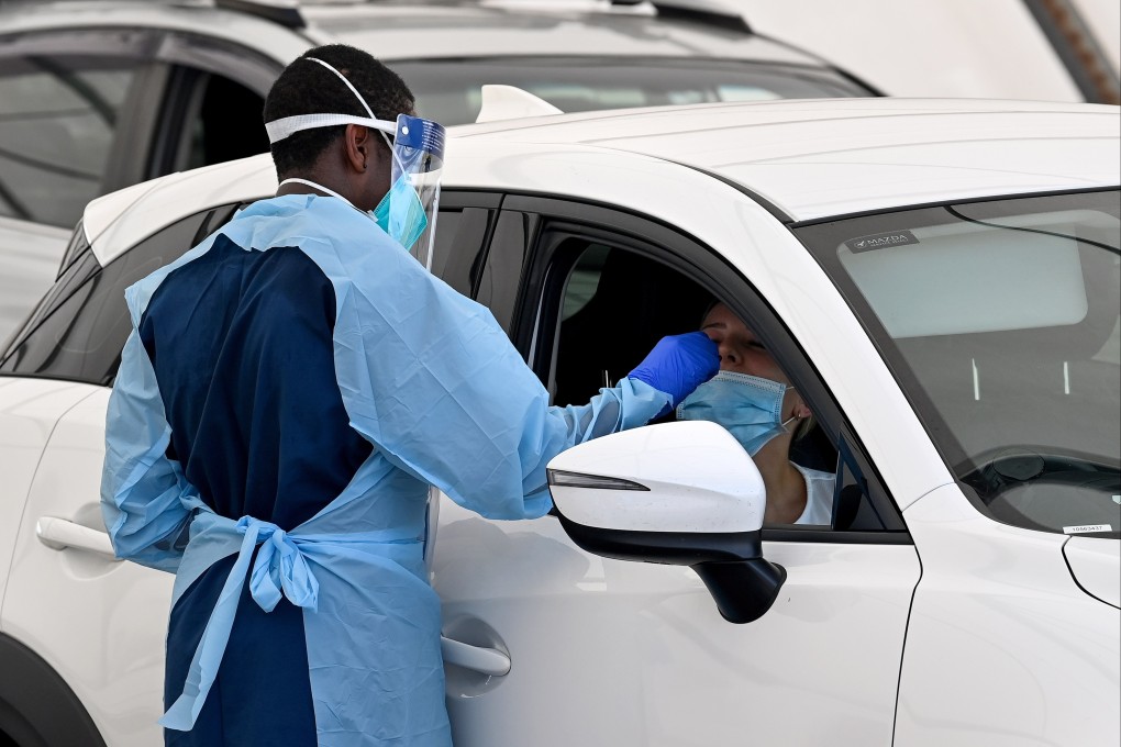 Health care workers administer Covid-19 tests at a drive-through testing clinic at Bondi Beach in Sydney. Photo: EPA-EFE