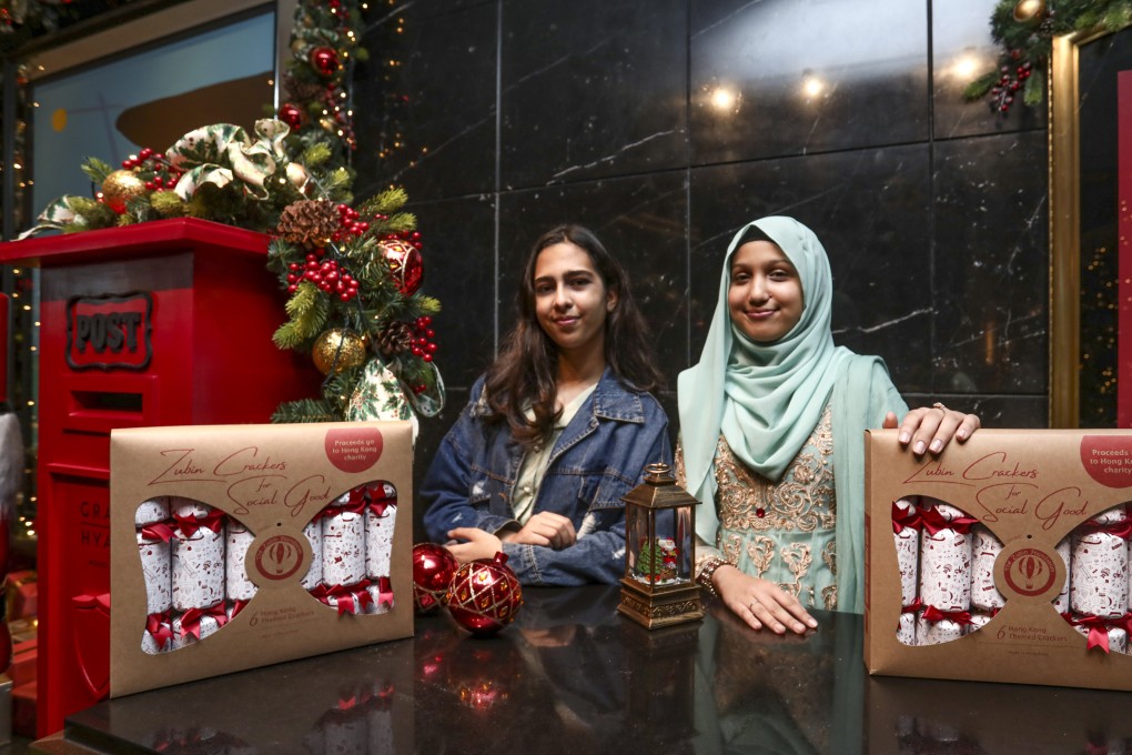 Students Aesha Ijaz (left) and Mehreen Hassan with the Christmas crackers their team produced through a Zubin Foundation project. Photo: Jonathan Wong