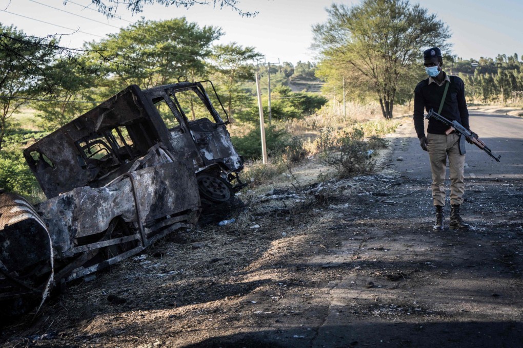 A police officer examines a destroyed military truck in Kemise, Ethiopia. Photo: AFP