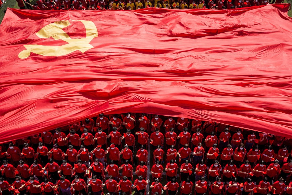 Students display the flag of the Communist Party of China to mark its 100th anniversary in Wuhan. Photo: AFP