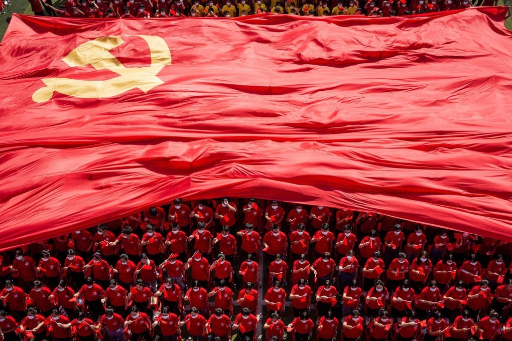 Students display the flag of the Communist Party of China to mark its 100th anniversary in Wuhan. Photo: AFP
