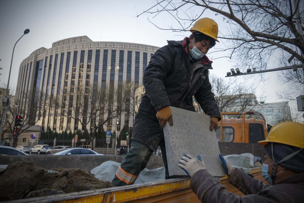 Workers unload a truck in front of the People’s Bank of China, in Beijing on December 13. Economists predict China will start adding fiscal stimulus in early 2022 after the country’s top officials said their key goals for the coming year include counteracting growth pressures and stabilising the economy. Photo: Bloomberg