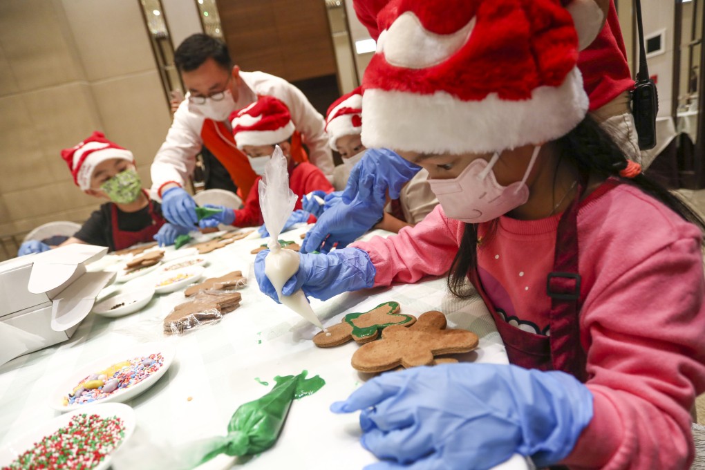 The Hong Kong Gold Coast Hotel last month welcomed 15 children from underprivileged familes for a day of Christmas activities, including making gingerbread men. Photo: Jonathan Wong