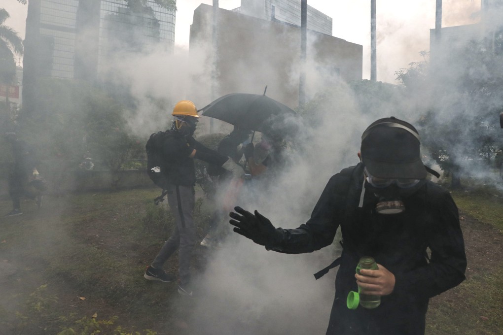 Anti-government protesters react to tear gas in Wan Chai on October 5, 2019. Photo: Sam Tsang