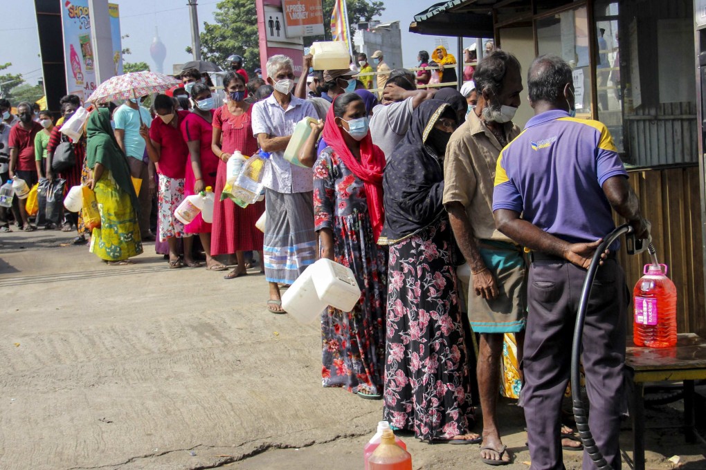 People queue to buy kerosene in Colombo on Thursday. Retail inflation in Sri Lanka jumped to 9.9 per cent in November, a 12-year high. Photo: AFP