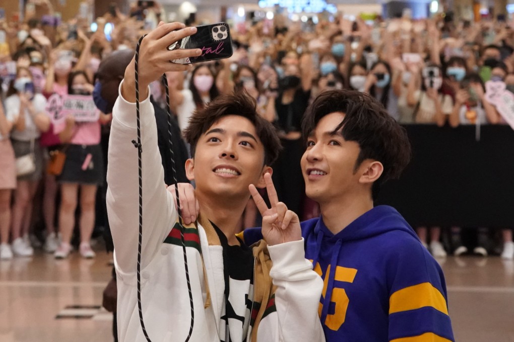 Edan Lui (left) and Anson Lo of boy band Mirror meet their adoring fans at a Gucci store in Harbour City, Tsim Sha Tsui. Luxury brands have flocked to use the Canto-pop group’s fame and popularity in marketing campaigns in 2021. Photo: Felix Wong