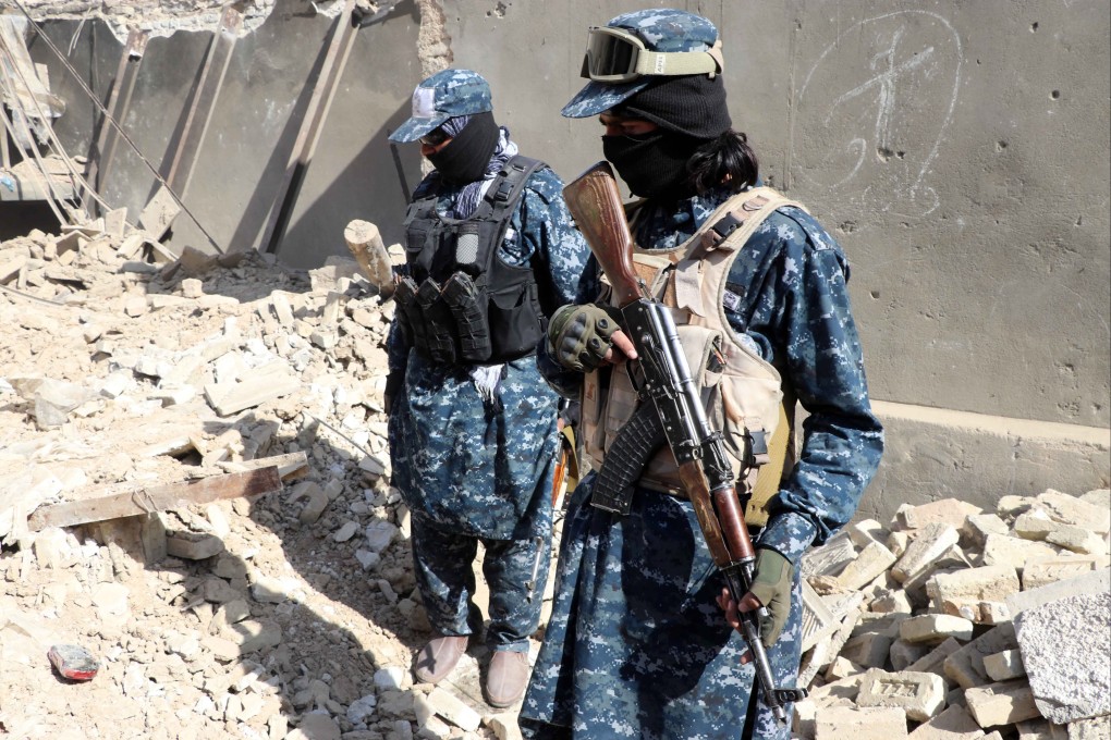 Taliban stand guard at the scene of an operation against an Isis hideout in Kandahar, Afghanistan. Photo: EPA-EFE