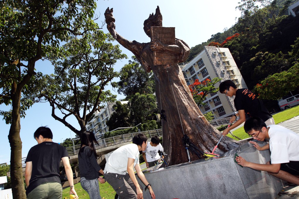 Chinese University student union members clean and decorate the Goddess of Democracy statue in 2012. The sculpture was removed from campus in the early hours of Christmas Eve. Photo: Sam Tsang