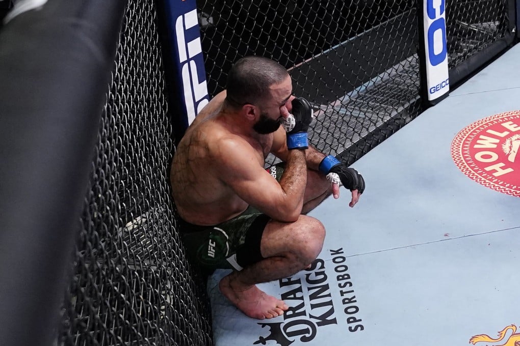 Belal Muhammad holds his eye after referee Herb Dean calls off his fight against Leon Edwards following an accidental eye poke. Photo: Jeff Bottari/Zuffa LLC via Getty Images