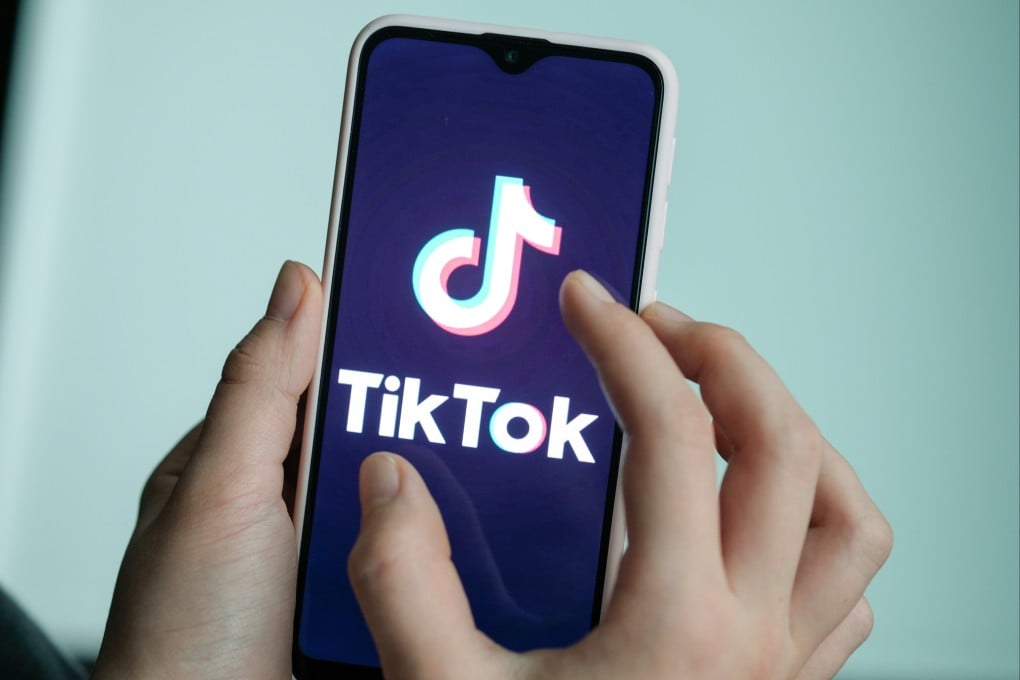 A girl is holding her smartphone with the logo of the short video app TikTok in her hands. Photo: dpa