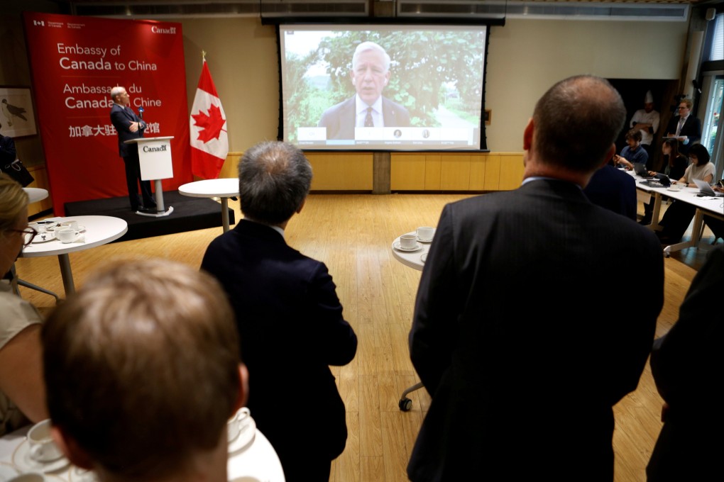 Dominic Barton speaks to journalists and diplomats via video link from Dandong. Photo: Reuters