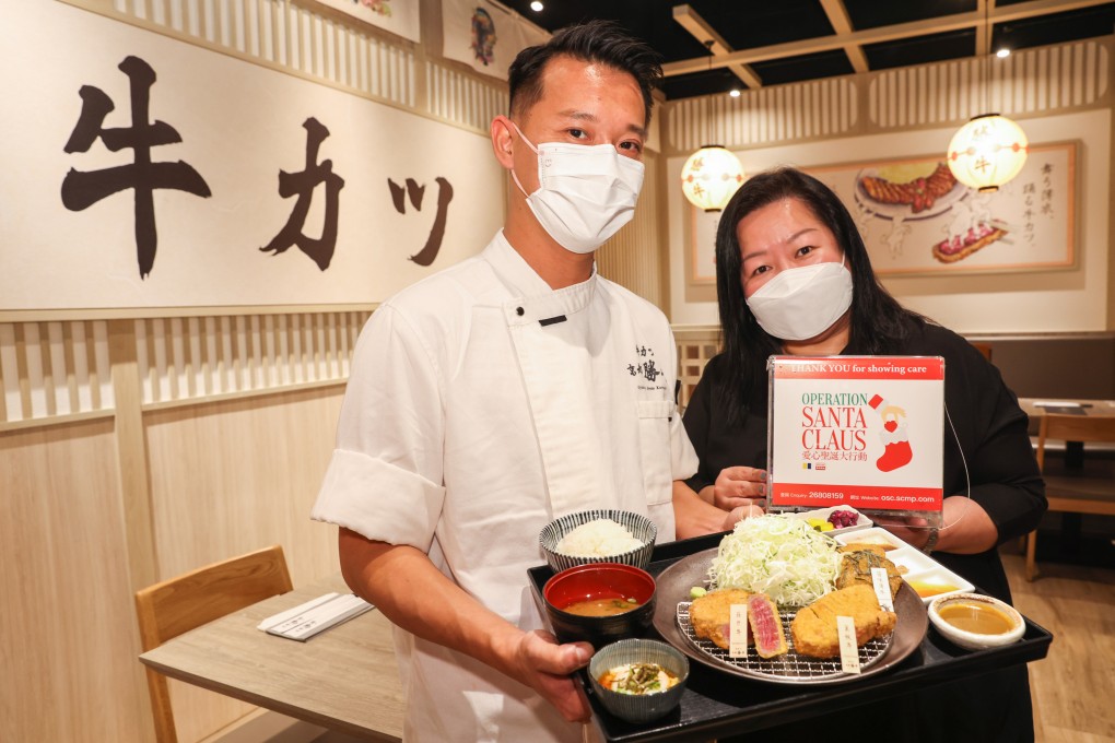 Chef Chan Tze-yeung and Café Deco Group director of sales and marketing Catherine Yuen show off a meal at Kyoto Katsugyu in Causeway Bay that raises money for Operation Santa Claus. Photo: Nora Tam