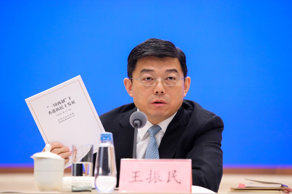 Tsinghua University law professor Wang Zhenmin with a copy of the white paper at the briefing on Beijing’s recent white paper on Hong Kong’s democratic development. Photo: Simon Song