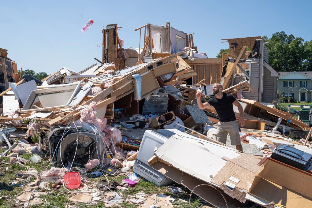 A man clears debris away from a house gutted by a tornado in the US state of New Jersey in September. Photo: AFP/Getty Images/TNS