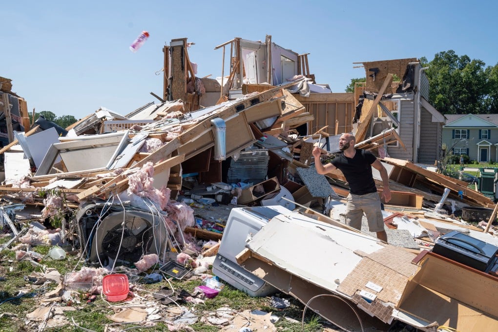 A man clears debris away from a house gutted by a tornado in the US state of New Jersey in September. Photo: AFP/Getty Images/TNS