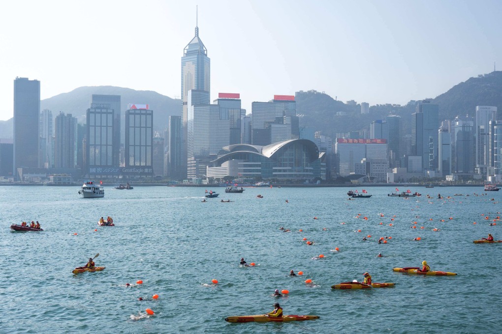 Swimmers swim across Victoria Harbour during an annual race in Hong Kong on December 12. Place and street names that reflect the city’s heritage should be embraced, not abandoned. Photo: AFP