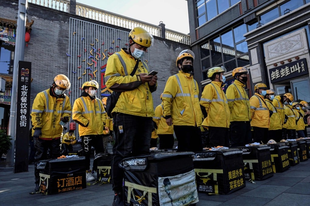 Food delivery drivers for Meituan stand in formation before starting work in Beijing. Photo: AFP