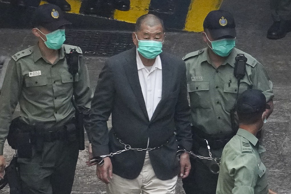 Media mogul Jimmy Lai is escorted to a prison van en route to a court appearance last year. Photo: Winson Wong