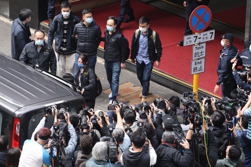 National security police escort Stand News acting editor-in-chief Patrick Lam from the outlet’s Kwun Tong office in handcuffs. Photo: May Tse