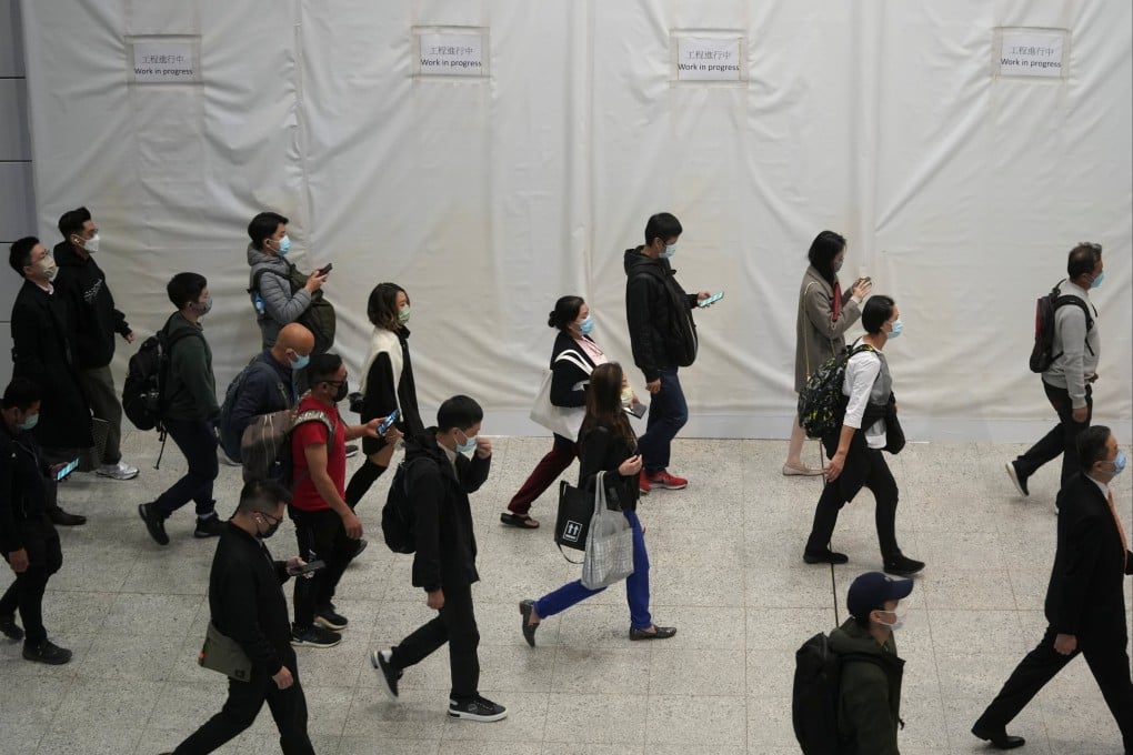 Commuters wearing masks to prevent the spread of the coronavirus disease walk through an MTR station in Hong Kong on December 1. Photo: Reuters