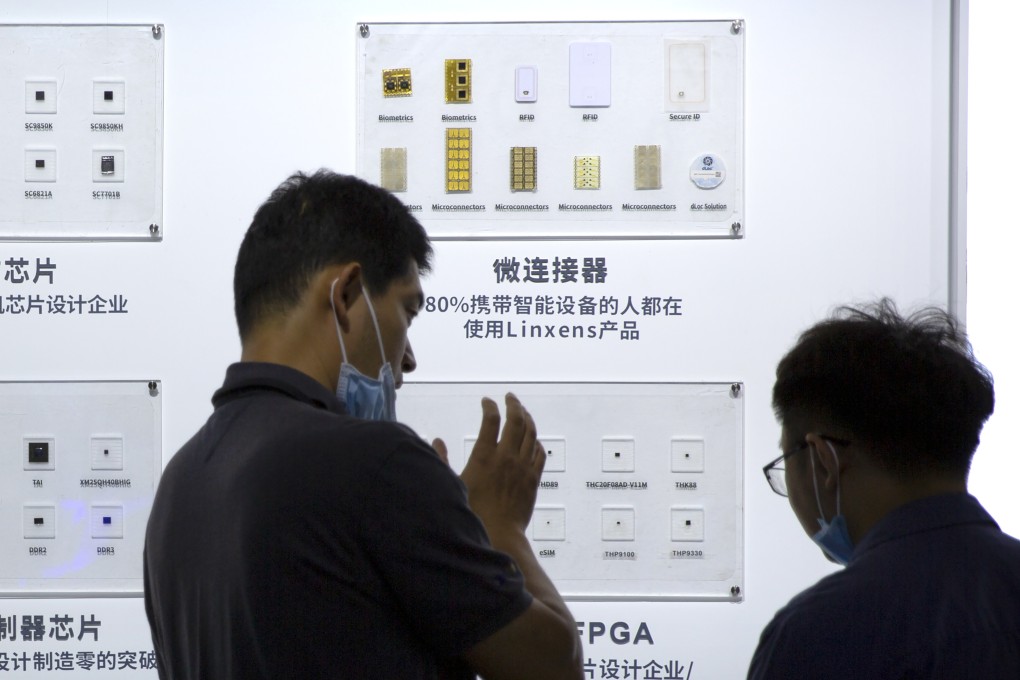 People check out semiconductors on display from Tsinghua Unigroup at an event in Beijing on September 19, 2020. Photo: AP