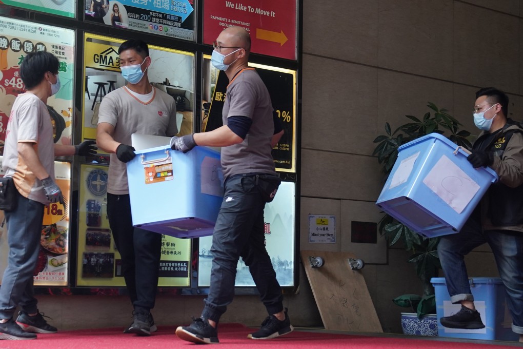 Hong Kong police take away items from the Stand News office in Kwun Tong. Photo: Sam Tsang