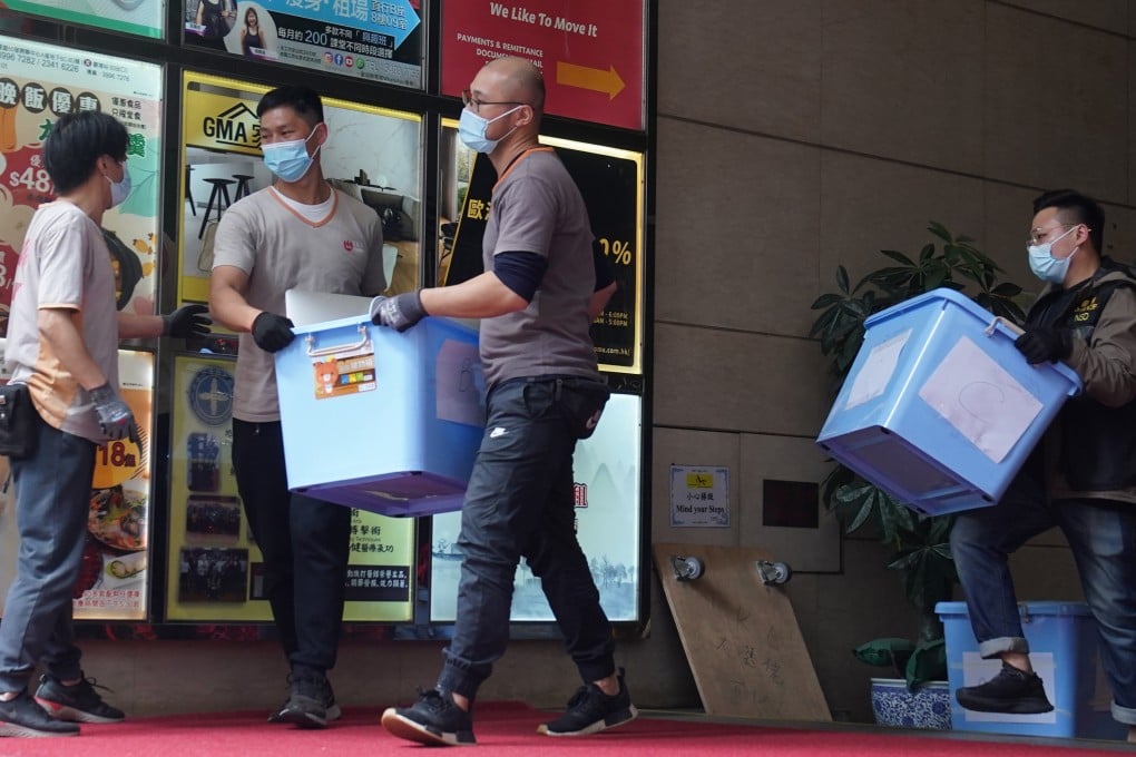 Hong Kong police take away items from the Stand News office in Kwun Tong. Photo: Sam Tsang