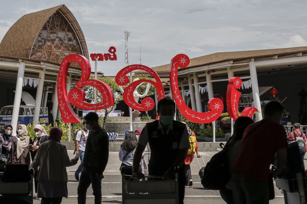 Domestic tourists at Bali’s international airport. They have flocked to the island in December, and the island is busier than at any time during the pandemic. Photo: Anadolu Agency via Getty Images