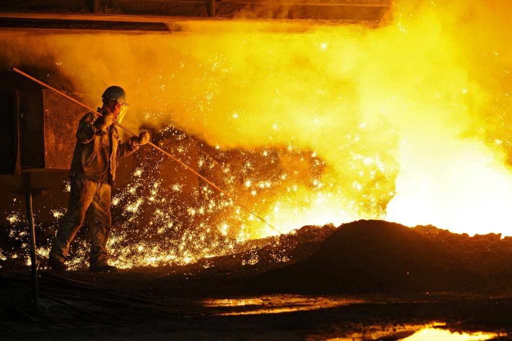 An employee works next to molten iron at a steel mill of Dongbei Special Steel in Dalian in Liaoning province on July 17, 2018. Photo: Reuters.