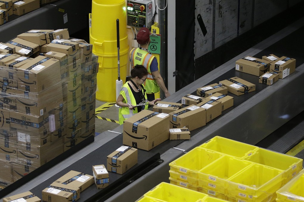 Packages move down a conveyor system where they are directed to the proper shipping area at an Amazon Fulfillment Center in Sacramento, California, on February 9, 2018. Photo: AP