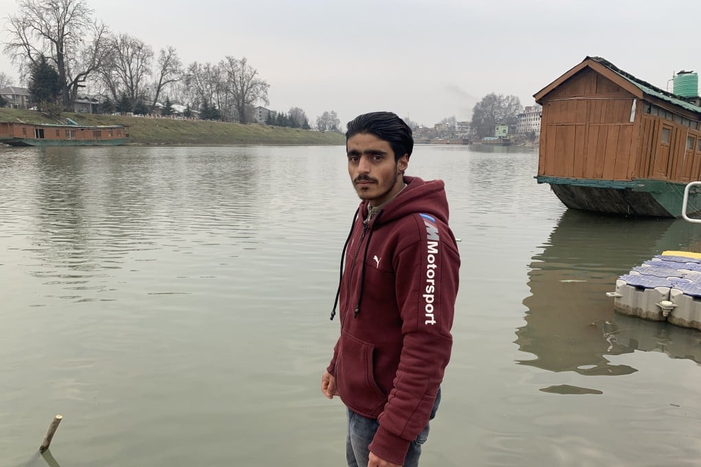 Bilal Ahmad Dar stands at the bank of the Jhelum river in the evening after finishing his Covid-19 duties for the day. Photo: Adnan Bhat