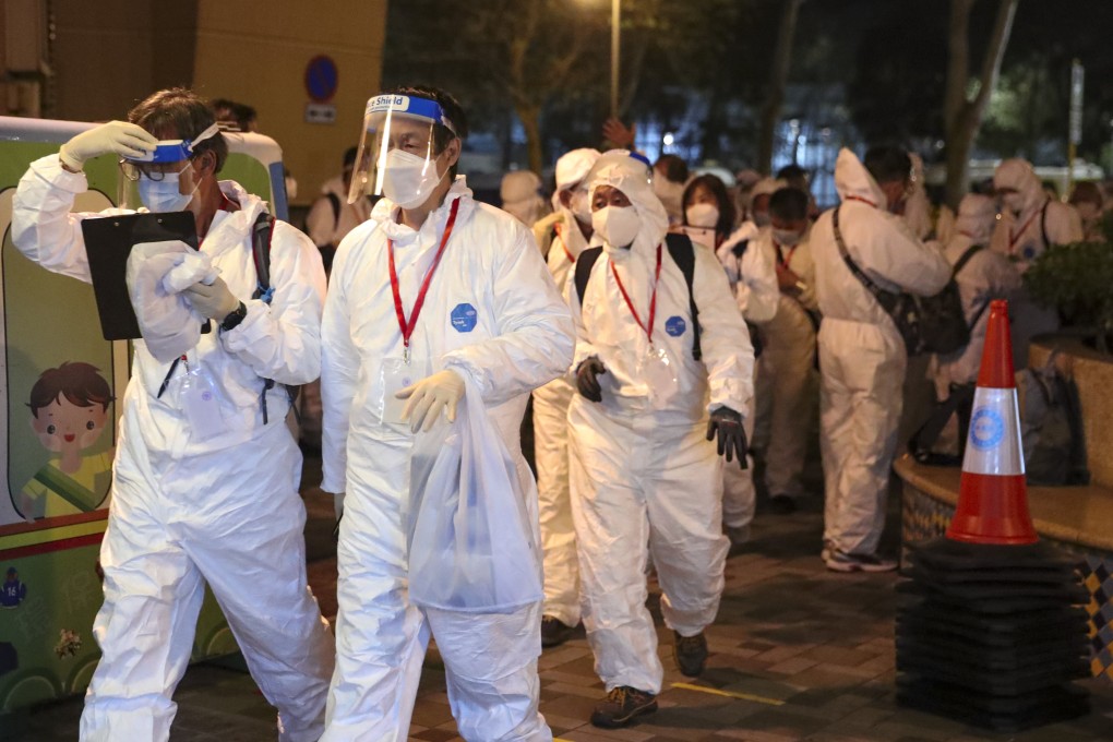 Goverment health workers prepare to carry out Covid-19 testing at Tower 6 of Caribbean Coast Phase 2 in Tung Chung after a suspected Covid-19 case was tied to the complex. Photo: Edmond So