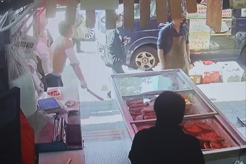 Surveillance footage shows a man snatching a knife from a meat shop in Kowloon City on Sunday. Photo: Dickson Lee