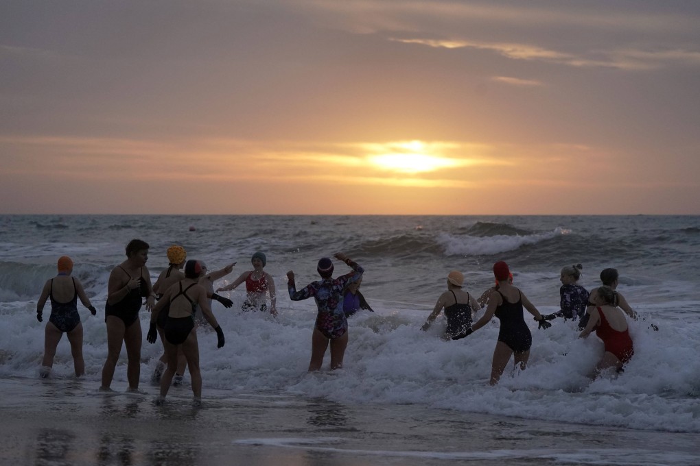 Swimmers take to the sea for the New Year’s Day swim at Boscombe beach in Dorset, England on January 1. Photo: AP