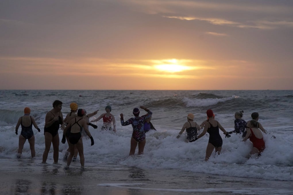 Swimmers take to the sea for the New Year’s Day swim at Boscombe beach in Dorset, England on January 1. Photo: AP