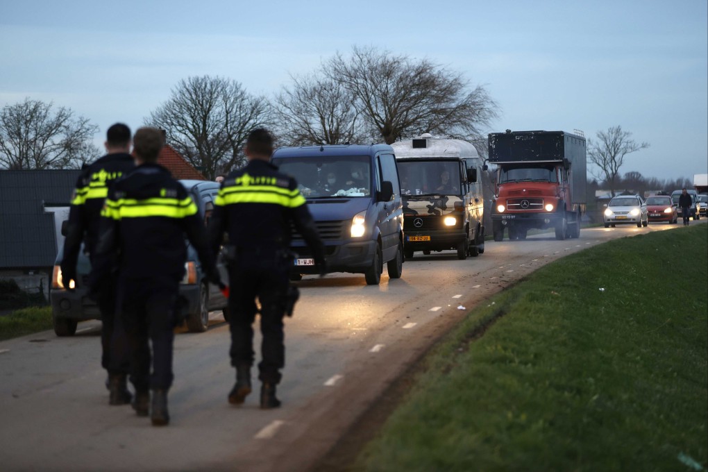 Police officers check cars leaving the site of a brick factory in Rijswijk, Netherlands, where an illegal party was held on New Year’s Day. Photo: EPA-EFE