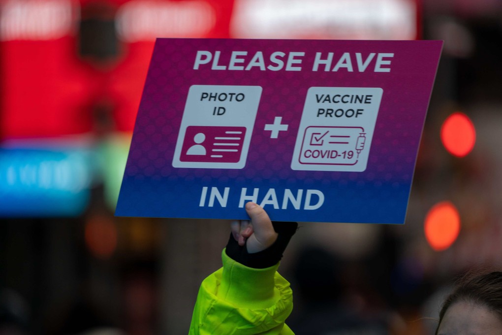 A person holds a sign at a checkpoint as revellers gather ahead of New Year’s Eve celebrations in New York’s Times Square on December 31. Despite record numbers of Covid-19 cases across the city and nationwide, the celebrations went ahead. Photo: Getty Images / AFP