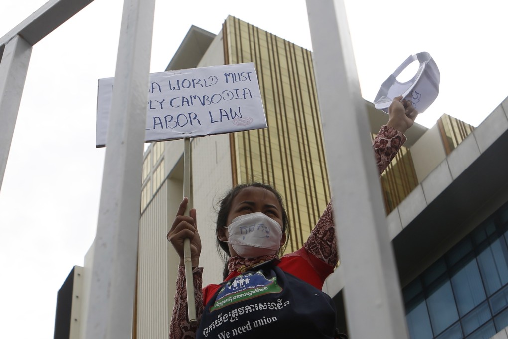 A Cambodian worker holds a banner near Nagaworld Casino in Phnom Penh, Cambodia, last month. Employees have been striking after the firm laid off more than 300 of them. Some have now been arrested. Photo: EPA-EFE