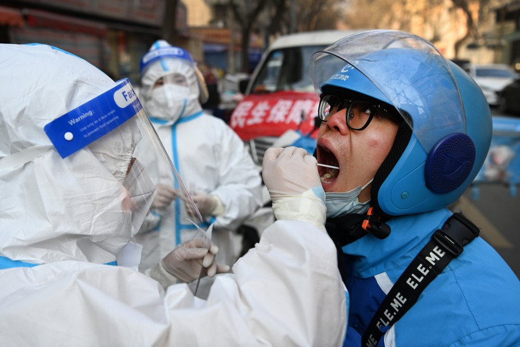 A courier gets tested at a mobile site in Xian’s Beilin district on Sunday. The city has just begun a seventh round of compulsory mass testing. Photo: Xinhua