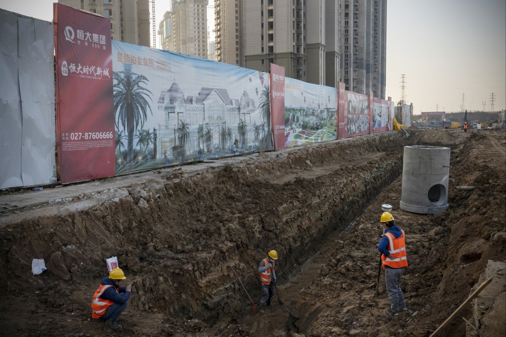 Workers at a construction site of a China Evergrande Group development in Wuhan, on December 22. The developer has more than US$300 billion of debts and is scrambling to raise cash. Photo: Bloomberg