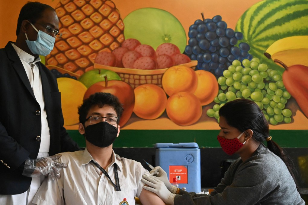 A health worker inoculates a student  in Kolkata. Photo: AFP