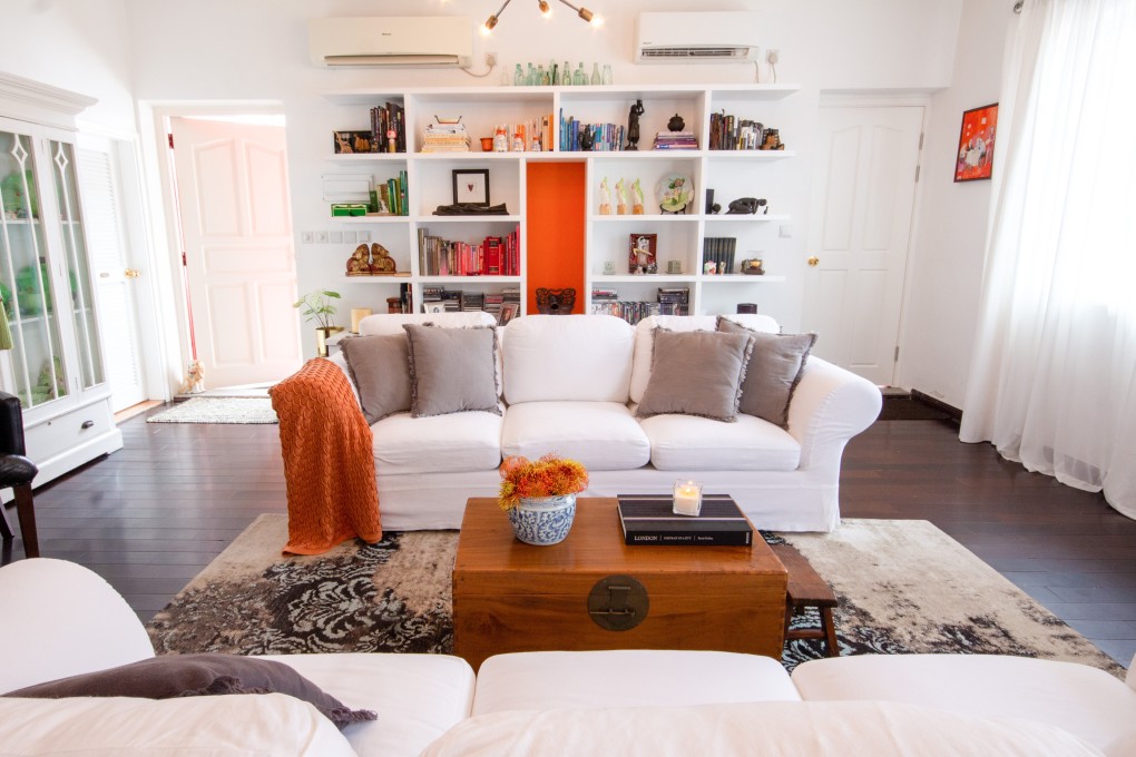 After having shelves installed across an entire wall in the living area upstairs, Eileen Stow opted for orange to pop from a central panel in the shelving. Styling and photography: Cassia Schutt