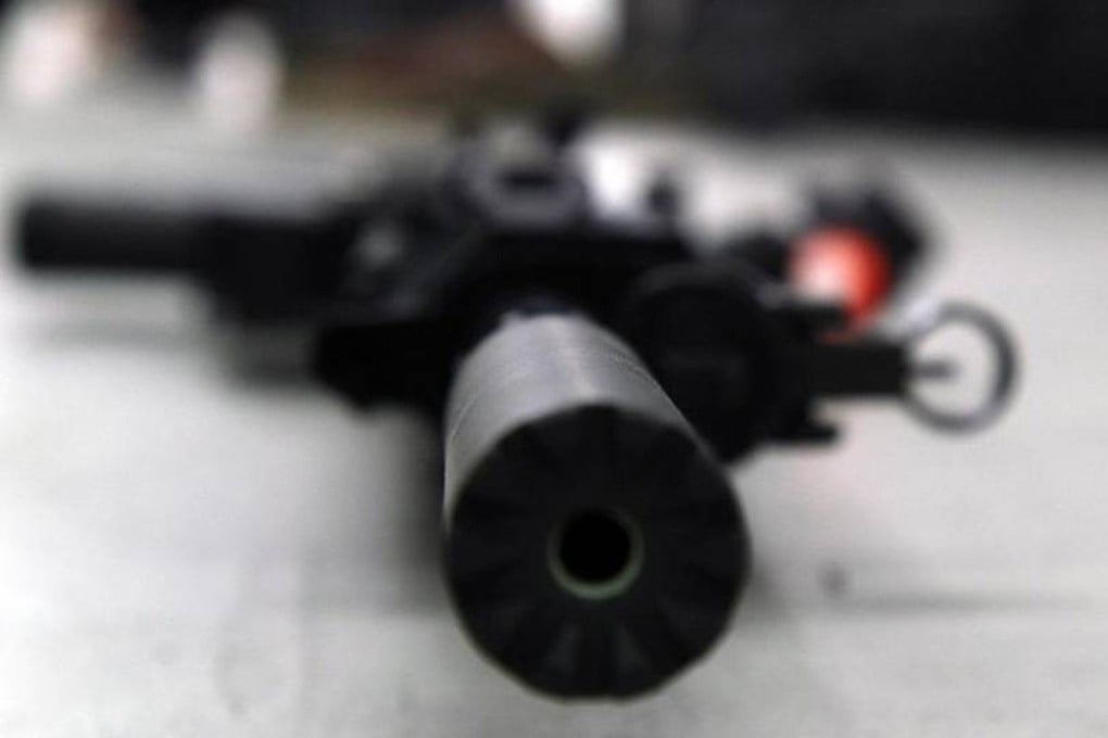 An AR-15 rifle with an attached silencer lies on the floor at a gun range at the NRA headquarters in Fairfax, Virginia. Photo: TNS