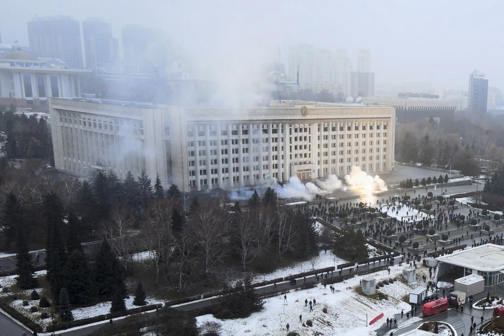 Smoke rises from the city hall building during a protest in Almaty, Kazakhstan, on Wednesday. There are reports that protesters angry about rising fuel prices broke into the mayor’s office in the country’s largest city and flames were seen coming from inside. Kazakh news site Zakon said many demonstrators who converged on the building carried clubs and shields. Photo: AP