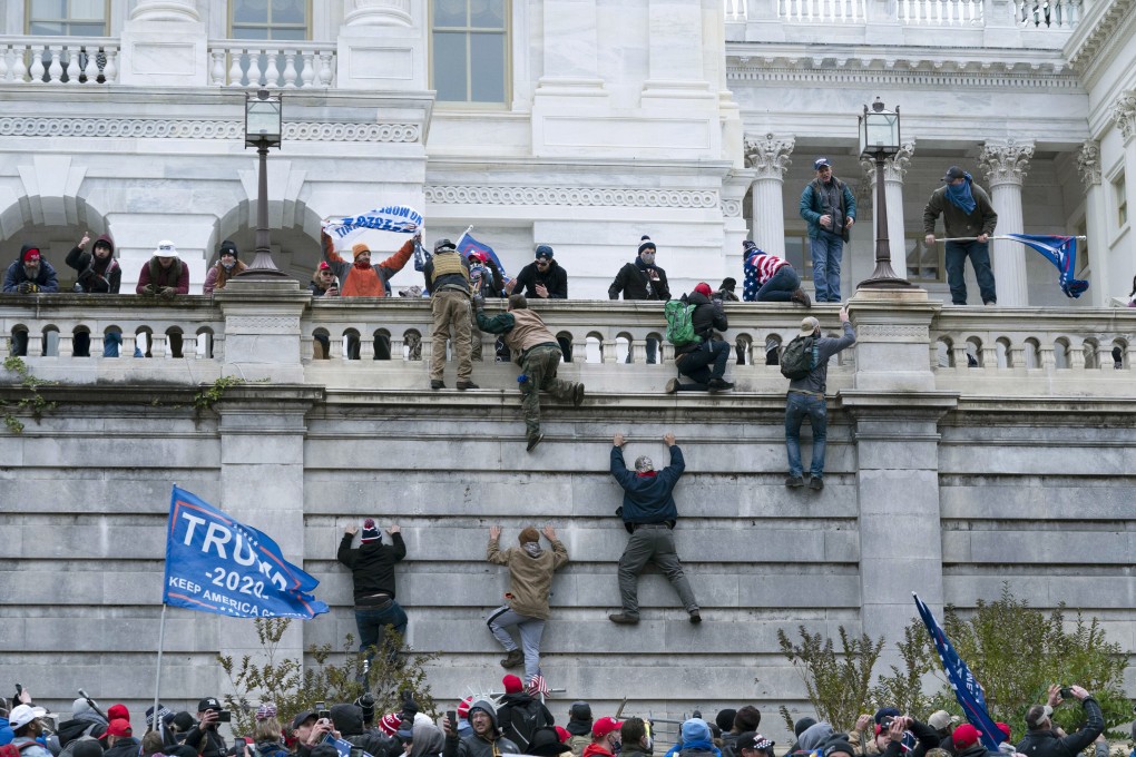 Violent insurrectionists loyal to then President Donald Trump climbed the west wall of the the US Capitol in Washington, Jan 6, 2021. Photo: AP Photo