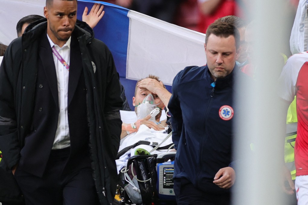 Denmark’s Christian Eriksen, 29, is evacuated after collapsing on the pitch with a heart attack, and being saved by CPR. Photo: Friedemann Vogel/AFP