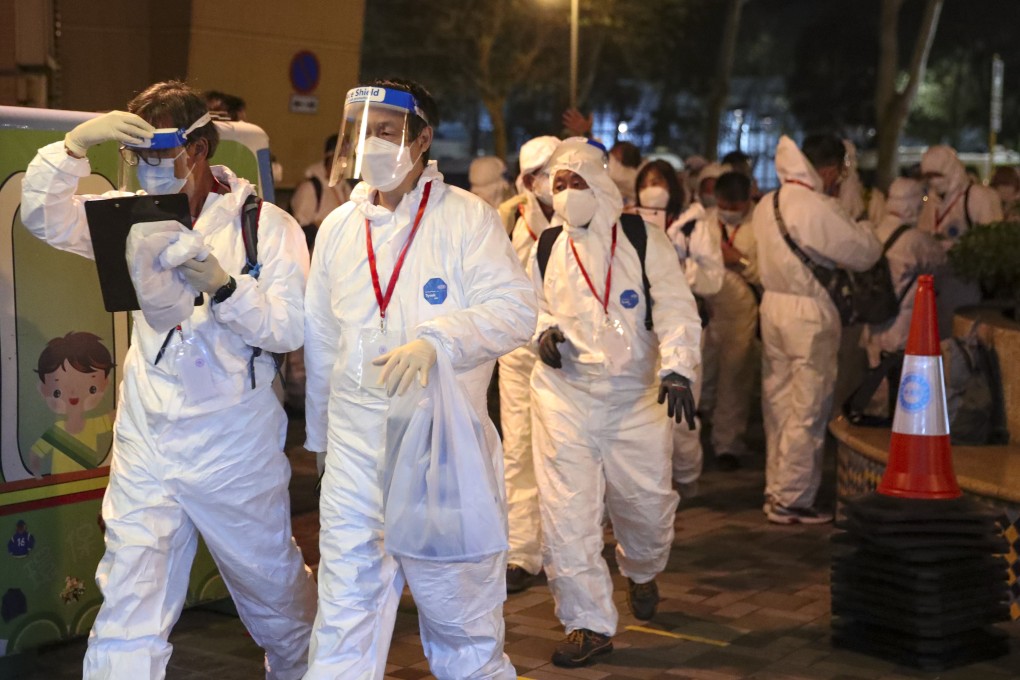 Residents at a block in Tung Chung undergo mandatory testing for Covid-19 on January 1 after a preliminary positive imported case was reported. Tracing and enforcing testing of thousands of people who may have been in hundreds of locations across the city is a tall order. Photo: Edmond So