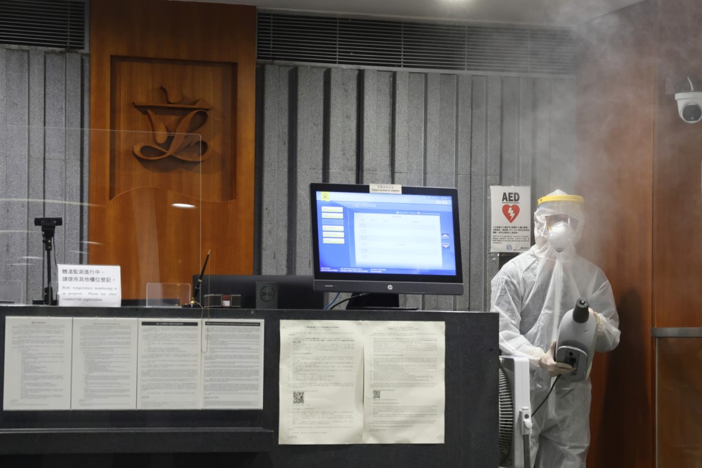 Disinfectant specialists spray anticeptic liquid in the reception of the LegCo Complex Building after top officials, lawmakers and politicans attended the birthday party of Witman Hung Wai-man, principal liaison officer for Hong Kong, Shenzhen Qianhai Authority. Photo: May Tse