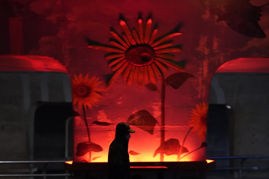 A visitor wearing a face mask to help curb the spread of the coronavirus walks past an illumination display at a park in Goyang, South Korea on Thursday. Photo: AP