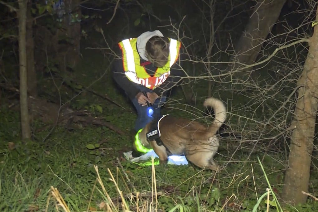 A policeman with a tracker dog searches for a missing man in Berlin in November 2020. Photo: dpa via AP